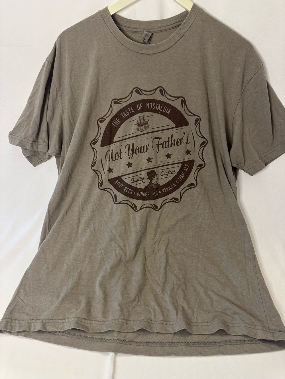 Next Level Apparel Taupe Short Sleeve Graphic Tee with Dark Brown Badge Print